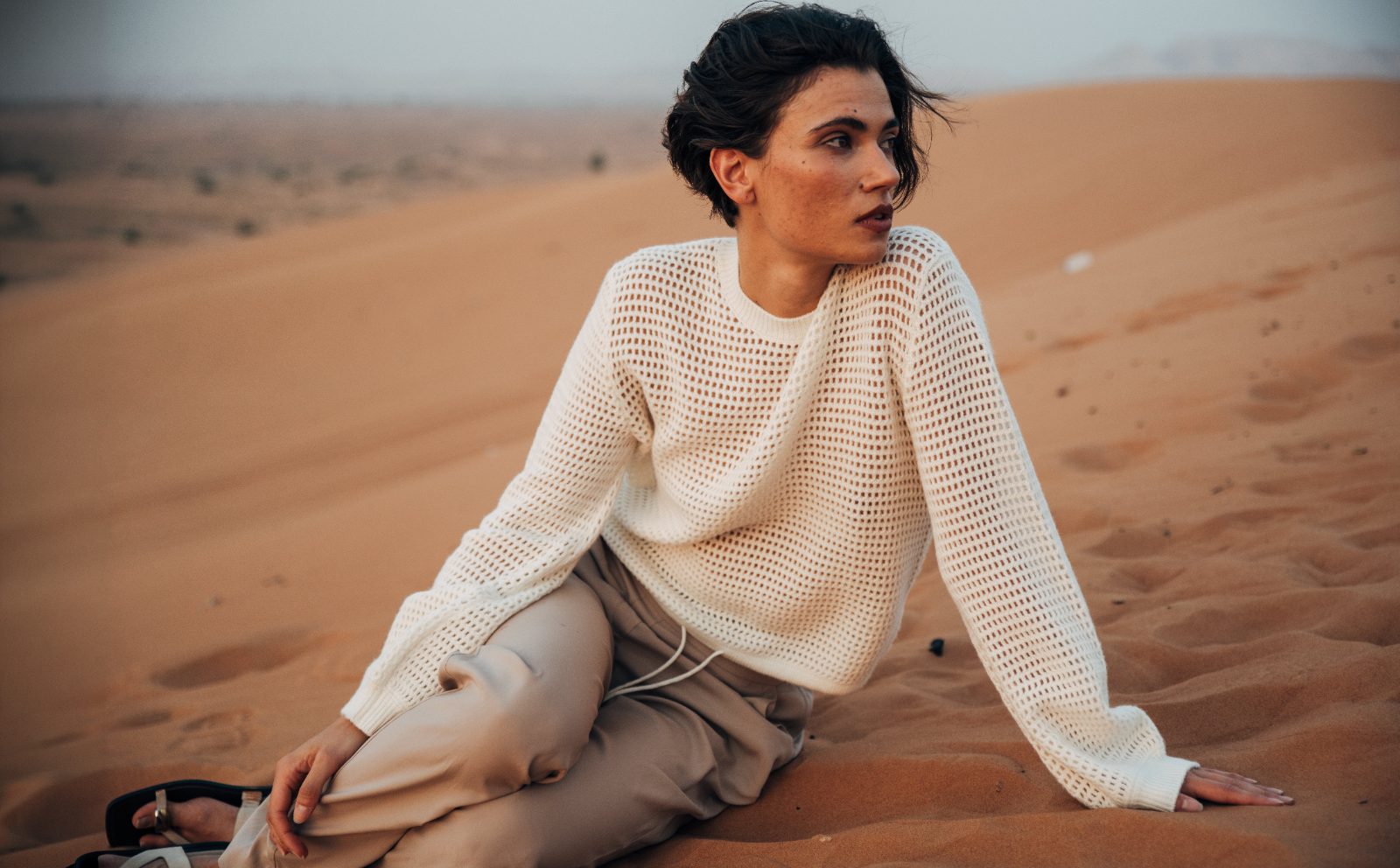 Seated in cream open-weave knit